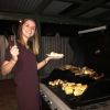 Rosie Burge OT student  using the BBQ at student accommodation